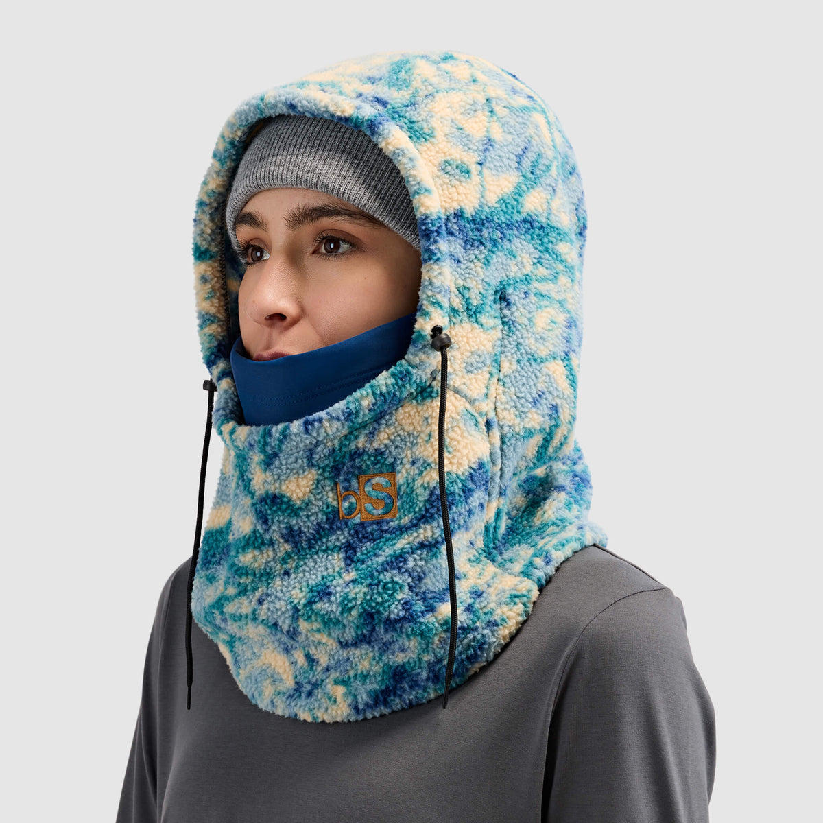 BlackStrap Caldera Hood Sherpa Fleece Overhood Pulse Deschutes worn by a woman wearing a beanie #color_pulse deschutes