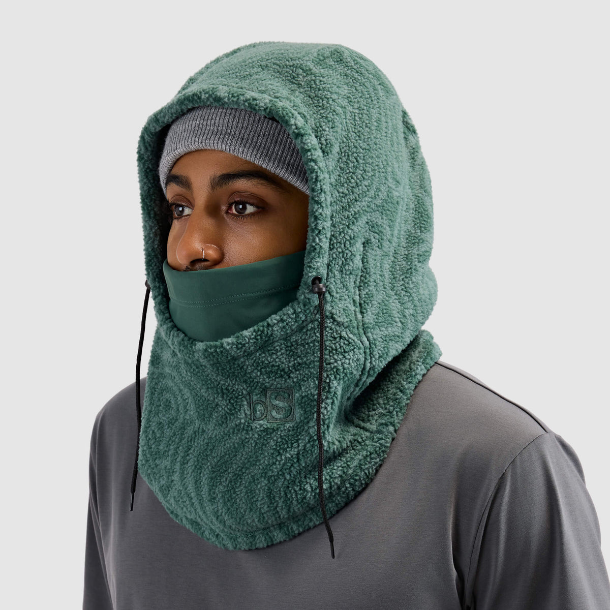 BlackStrap Caldera Hood Sherpa Fleece Overhood Inprint Obsidian worn by a man wearing a beanie #color_inprint obsidian