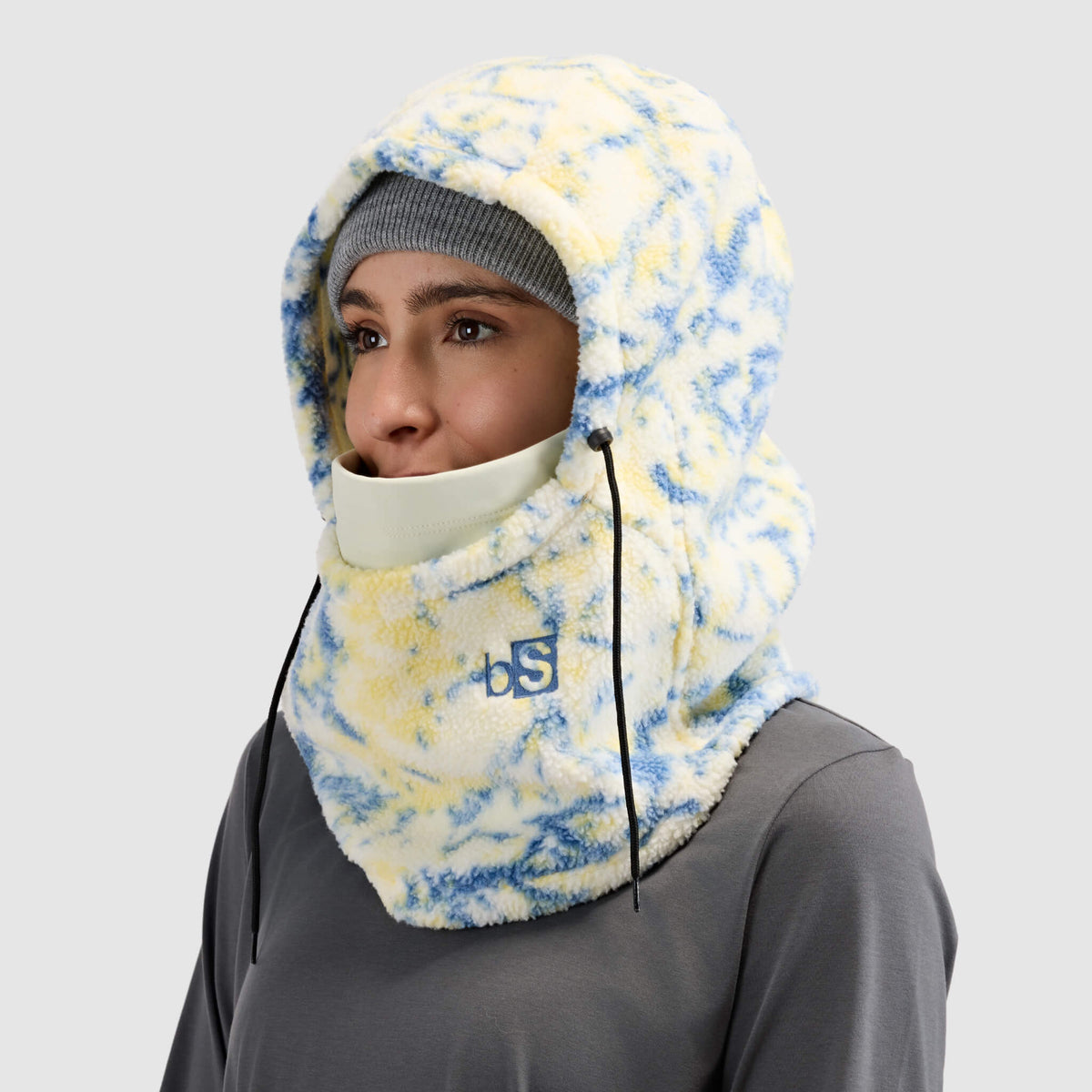 BlackStrap Caldera Hood Sherpa Fleece Overhood Pulse Orion worn by a woman wearing a beanie #color_pulse orion