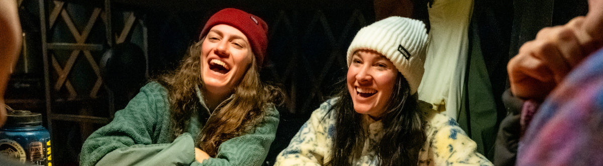 Two friends sharing a laugh in their comfortable BlackStrap Beanies