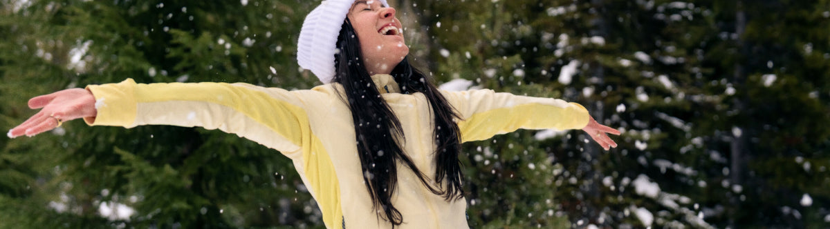 Women enjoying the early season snow in her New Tribrid grid fleece mid layer.