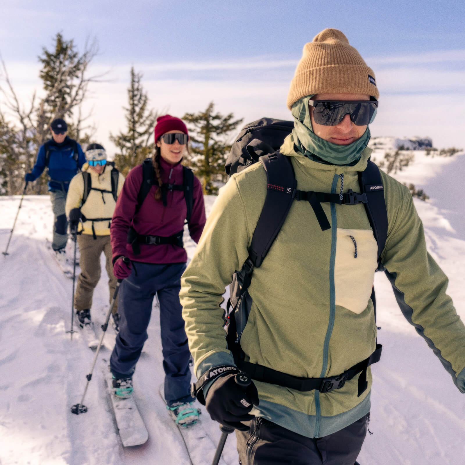 Four friends on a cross country adventure on their ski's wearing their BlackStrap Mid Layers